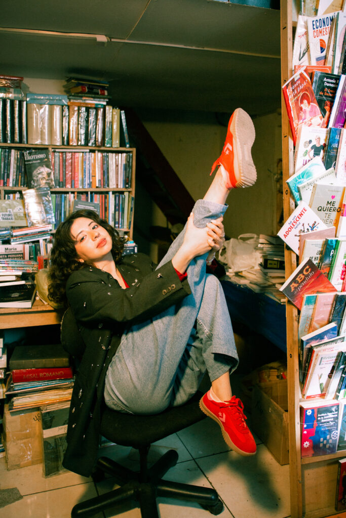 This image shows one person sitting and showing their shoes.